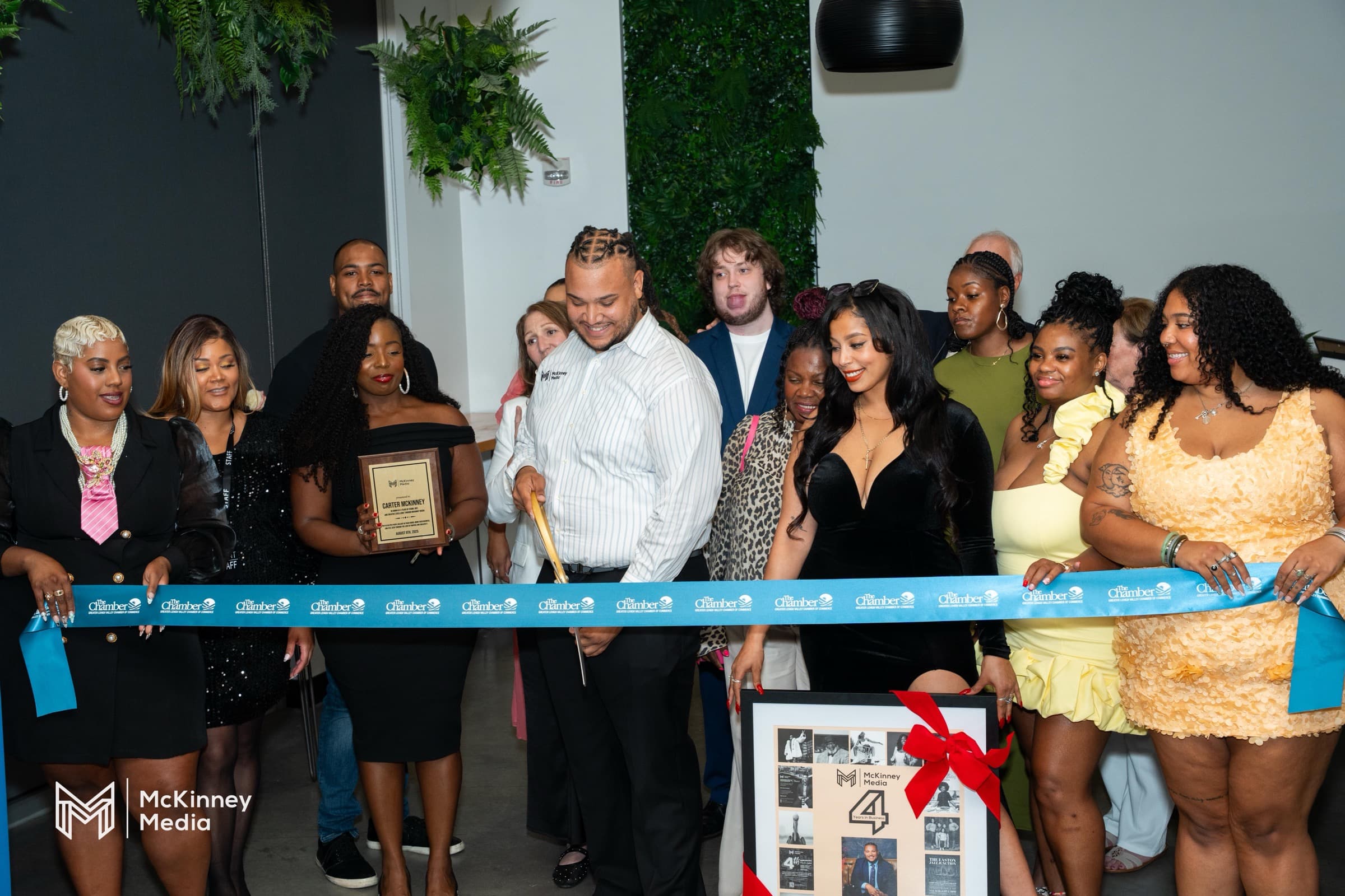 Carter McKinney cutting the ribbon at McKinney Media's 4th anniversary and School launch celebration