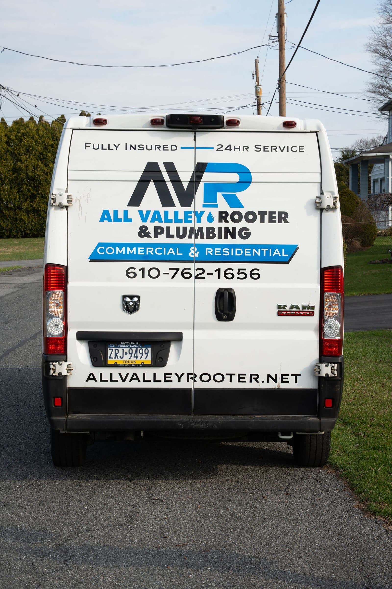 Rear of the All Valley Rooter service van showing its phone number and website